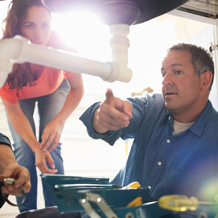 plumber discussing sink issue with client
