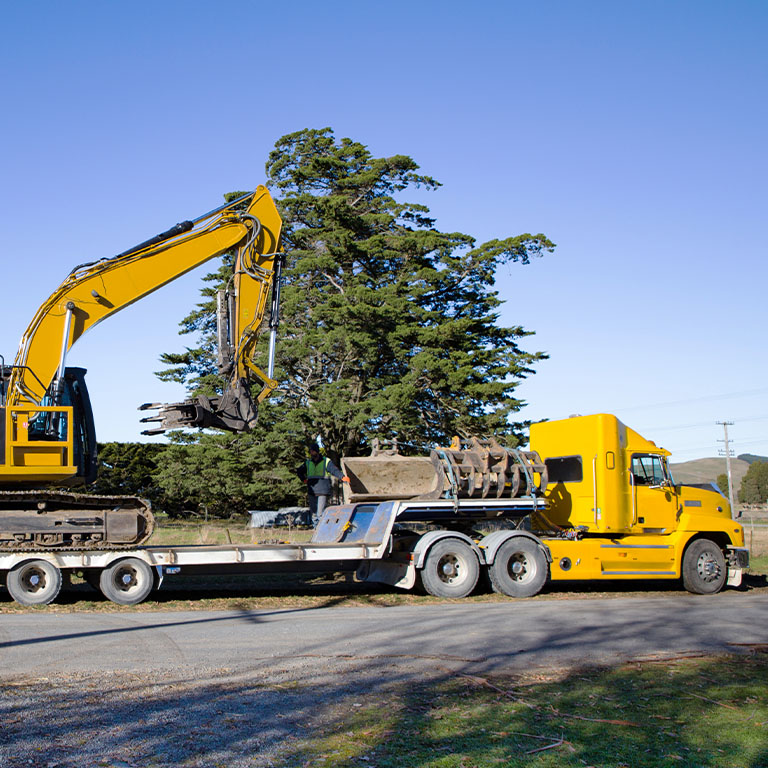 Yellow truck driving into contruction site