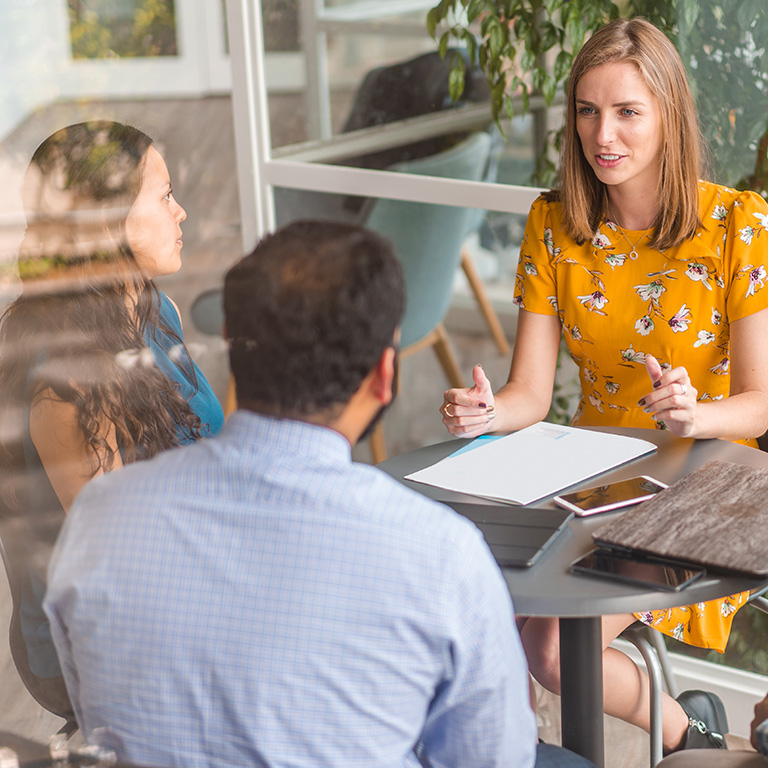 female insurance broker talking to clients                                                  